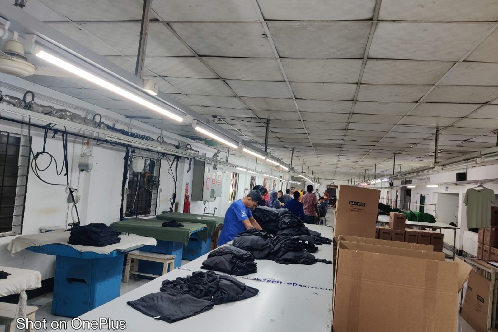 H & MR Supply Chain garments factory — industrial sewing machines and fabric work in progress