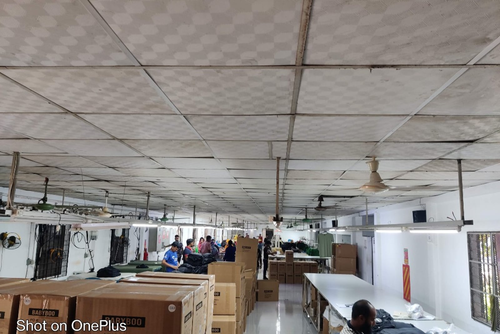 H & MR Supply Chain garments factory — packing and quality-control floor